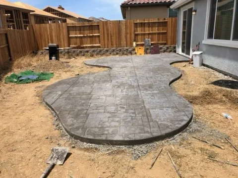 Stamped concrete backyard patio, freeform edge