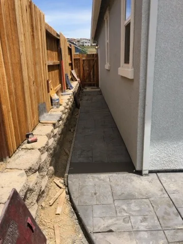 Stamped slate walkway along home